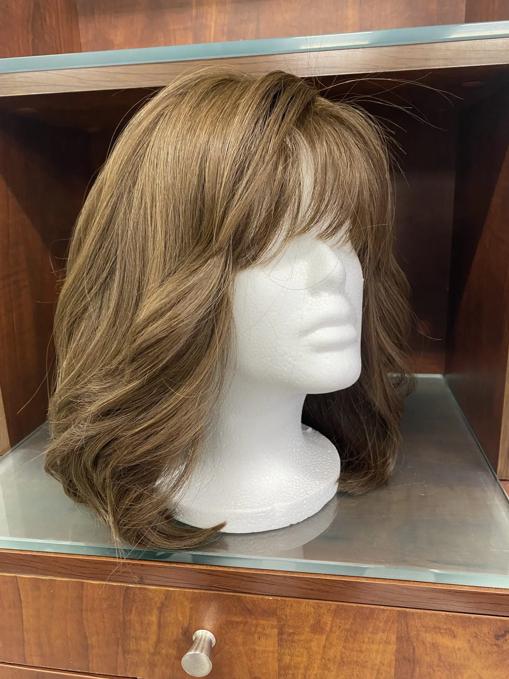 Brown wavy bob wig on mannequin.