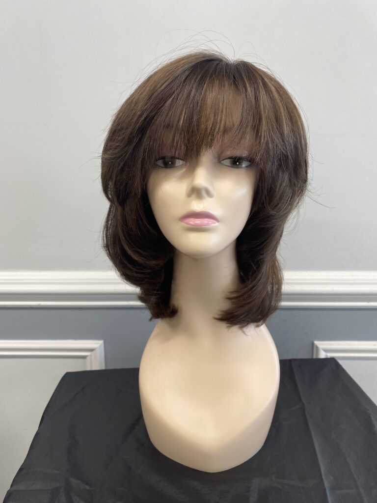 Brown bob wig with bangs on mannequin.